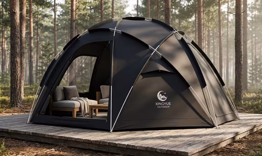 A portable geodesic dome tent from Xingyue Outdoor set on a wooden deck in a forest, representing a professional temporary glamping structure.